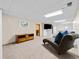 Finished basement featuring stylish lounge chairs, a mounted tv, and recreational space at 4779 S Owens Way, Littleton, CO 80127