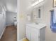 Bathroom with a white vanity, framed mirror, and neutral color palette at 4779 S Owens Way, Littleton, CO 80127