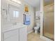 Bright bathroom with a white vanity, framed mirror, and walk-in shower at 4779 S Owens Way, Littleton, CO 80127