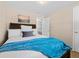 Comfortable bedroom with a queen bed, soft lighting, and a connecting doorway at 4779 S Owens Way, Littleton, CO 80127