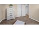 Neutral bedroom features a dresser and two closets, bathed in natural light at 4779 S Owens Way, Littleton, CO 80127