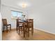 Comfortable dining area featuring natural light, hardwood floors, and a classic table setting at 4779 S Owens Way, Littleton, CO 80127