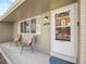 Cozy front porch features chairs, a small window, and the house number, creating a welcoming entrance at 4779 S Owens Way, Littleton, CO 80127