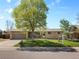 Charming single-story home featuring a well-maintained lawn, large shade tree and an attached two-car garage at 4779 S Owens Way, Littleton, CO 80127
