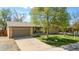 Charming single-story home featuring a well-maintained lawn, large shade tree and an attached two-car garage at 4779 S Owens Way, Littleton, CO 80127