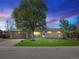 Charming single-story home featuring a well-maintained lawn, large shade tree and an attached two-car garage at 4779 S Owens Way, Littleton, CO 80127