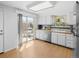 Spacious kitchen with stainless steel appliances, wood countertops, and access to outdoor patio at 4779 S Owens Way, Littleton, CO 80127