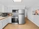 Updated kitchen with sleek stainless steel refrigerator and oven, and butcher block countertops at 4779 S Owens Way, Littleton, CO 80127