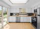 Well-lit kitchen boasting white cabinets, wood countertops, and modern stainless steel appliances at 4779 S Owens Way, Littleton, CO 80127