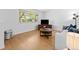 Cozy living room featuring wood-look floors, a large window, and neutral decor at 4779 S Owens Way, Littleton, CO 80127