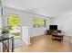 Bright living room boasts hardwood floors, large windows and a modern TV setup, creating a cozy atmosphere at 4779 S Owens Way, Littleton, CO 80127