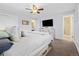 Comfortable main bedroom featuring a bed with storage, a ceiling fan, and an ensuite bathroom at 4779 S Owens Way, Littleton, CO 80127