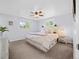 Tranquil main bedroom featuring a ceiling fan, two windows, and stylish decor at 4779 S Owens Way, Littleton, CO 80127