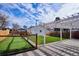 Landscaped backyard with putting green, pergola, and detached garage at 2686 Poplar St, Denver, CO 80207