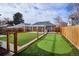 Artificial turf backyard with putting green and wooden fence at 2686 Poplar St, Denver, CO 80207