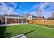 Brick home with artificial turf, putting green, and pergola at 2686 Poplar St, Denver, CO 80207