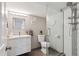 Updated bathroom features a walk-in shower, modern vanity, and stylish tile at 2686 Poplar St, Denver, CO 80207