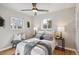 Cozy bedroom with a queen-size bed, hardwood floors, and ample natural light at 2686 Poplar St, Denver, CO 80207