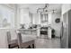 Modern kitchen with white cabinets, stainless steel appliances, and granite countertops at 2686 Poplar St, Denver, CO 80207