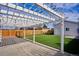 White pergola with string lights creates a shaded patio area at 2686 Poplar St, Denver, CO 80207