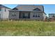 Back exterior view, showing a covered patio and fenced yard with a view of the home's rear facade at 16655 W 93Rd Pl, Arvada, CO 80007
