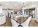 Open concept dining area with modern lighting, access to patio, and a view of the kitchen at 16655 W 93Rd Pl, Arvada, CO 80007