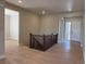 Inviting foyer with wood floors and an elegant staircase leading to the upper level of the home at 16655 W 93Rd Pl, Arvada, CO 80007