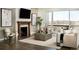 Cozy living room with fireplace, neutral decor, and access to the backyard and outdoor space at 16655 W 93Rd Pl, Arvada, CO 80007