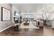 Open-concept living space showcasing stylish furnishings, a fireplace, and seamless flow to the kitchen and dining areas at 16655 W 93Rd Pl, Arvada, CO 80007