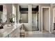 Elegant main bathroom featuring double shower and vanity with modern fixtures and decor at 16655 W 93Rd Pl, Arvada, CO 80007