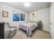 Neutrally-toned bedroom features a big window, soft carpet, and soft chair at 1857 W 67Th Pl, Denver, CO 80221