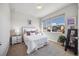 Cozy bedroom features a bright window, neutral decor, and comfortable furnishings at 1857 W 67Th Pl, Denver, CO 80221