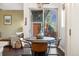 Cozy dining area with a round table, stylish chairs, and access to a patio at 1857 W 67Th Pl, Denver, CO 80221