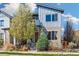 Modern two-story home with blue and tan exterior and landscaped front yard at 1857 W 67Th Pl, Denver, CO 80221