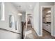 Upstairs hallway leading to the bedrooms and a well-lit bathroom with modern fixtures at 1857 W 67Th Pl, Denver, CO 80221