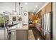Modern kitchen with stainless steel appliances, a breakfast bar, and stylish pendant lighting at 1857 W 67Th Pl, Denver, CO 80221