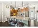 Stylish kitchen boasts a large island with bar seating, stainless appliances, and ample cabinet space at 1857 W 67Th Pl, Denver, CO 80221