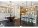 Open concept kitchen and dining area with stainless steel appliances, an island, and bar stool seating at 1857 W 67Th Pl, Denver, CO 80221