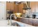 Close-up of the kitchen with stainless steel appliances, modern cabinets, and a mosaic tile backsplash at 1857 W 67Th Pl, Denver, CO 80221