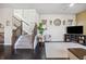 Bright living room with dark hardwood floors and a staircase leading to the second floor at 1857 W 67Th Pl, Denver, CO 80221