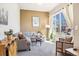 Comfortable living room with a sectional sofa, bright window, and stylish decor at 1857 W 67Th Pl, Denver, CO 80221