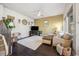 Open-concept living room with a ceiling fan, large window, and stairs leading to the upper level at 1857 W 67Th Pl, Denver, CO 80221