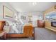 Tranquil main bedroom with a cozy fireplace and view of the bathroom at 1857 W 67Th Pl, Denver, CO 80221
