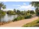 Picturesque river view framed by lush greenery, and a walking path, inviting outdoor adventures at 1857 W 67Th Pl, Denver, CO 80221
