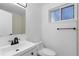 Clean bathroom featuring a single vanity sink, toilet, mirror, and a minimalist aesthetic at 4552 S Buckley Way, Aurora, CO 80015