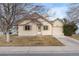 Tan single-story home with a manicured lawn and attached one car garage at 4552 S Buckley Way, Aurora, CO 80015