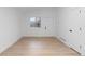 Bright living room featuring light wood floors, white walls and contemporary doors and trim at 4552 S Buckley Way, Aurora, CO 80015