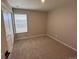 Bright bedroom with neutral walls and carpet at 9446 Yampa Ct, Commerce City, CO 80022