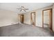 Large bedroom featuring carpet floors, a ceiling fan, and access to a bathroom at 250 Cypress Ln, Broomfield, CO 80020
