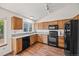Traditional kitchen featuring wood cabinets, modern appliances, and wood flooring at 250 Cypress Ln, Broomfield, CO 80020